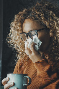 Close-up of young woman drinking coffee