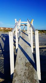 Built structure on beach against clear blue sky