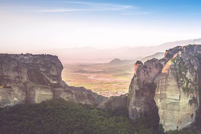 Scenic view of mountains against cloudy sky