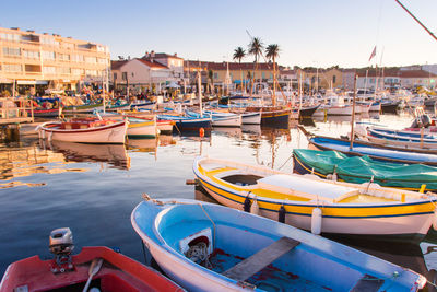 Boats moored at harbor in city