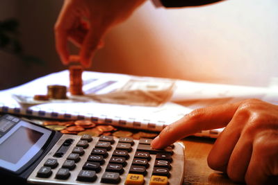 Business person using calculator at desk in office