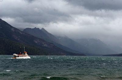 Scenic view of sea and mountains against sky