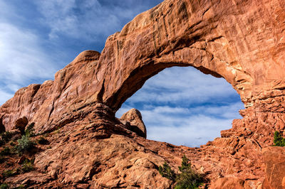 Low angle view of rock formation against sky