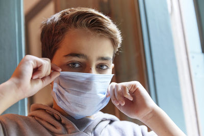 Close-up portrait of boy wearing mask