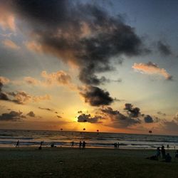 People on beach at sunset