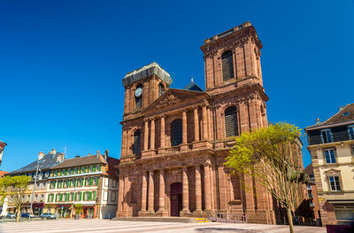 Low angle view of historical building against blue sky