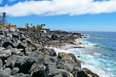 Rocks on shore against sky