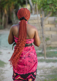 African woman dressed in traditional clothes walks through the village of keta ghana west africa