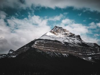 Low angle view of snowcapped mountain against sky