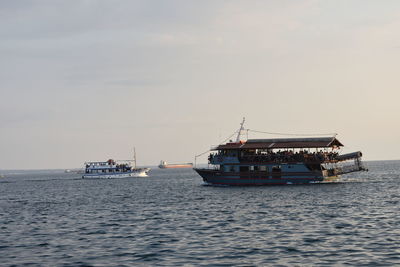 Ship sailing on sea against sky