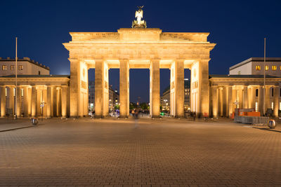 Statue in city at night