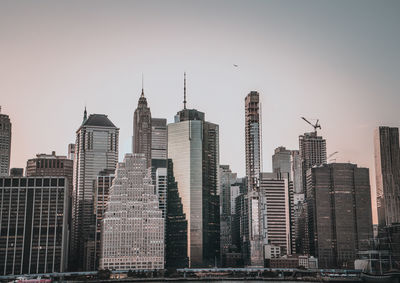 Buildings in city against clear sky