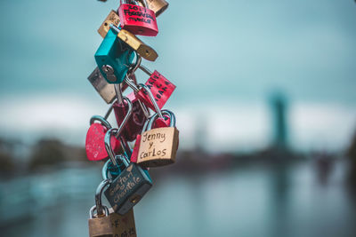 Close-up of padlocks hanging on bridge