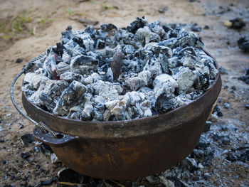 High angle view of cast iron pot with coal