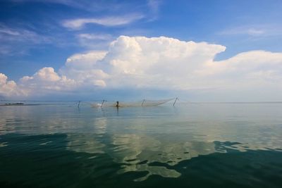 Scenic view of sea against cloudy sky