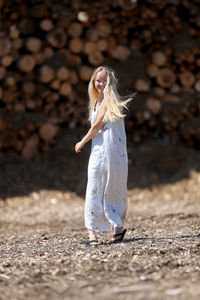 Low section of woman with umbrella on land