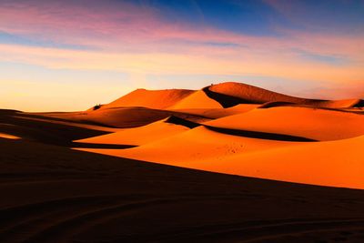 Scenic view of desert against sky during sunset