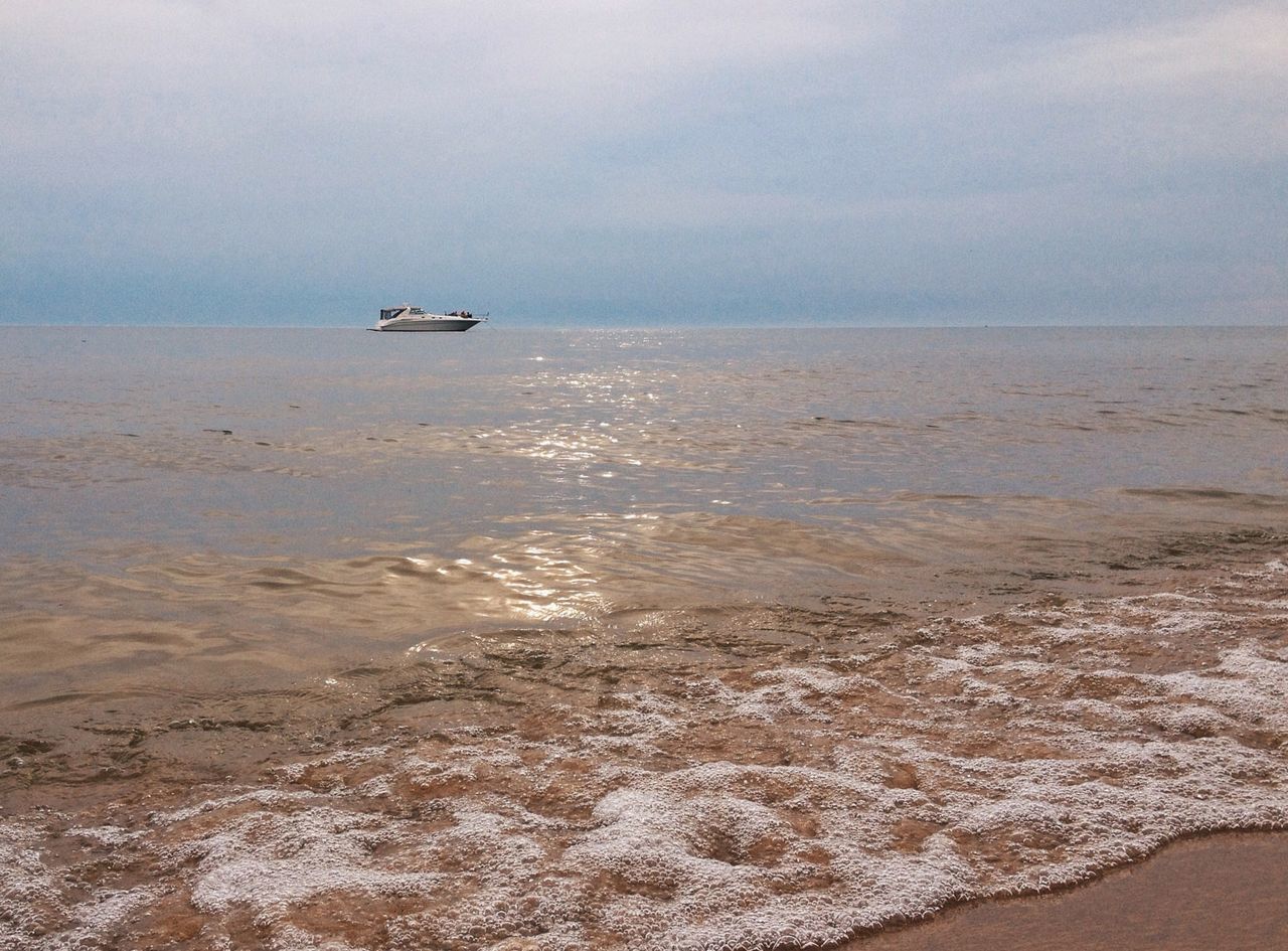 sea, horizon over water, water, beach, nautical vessel, mode of transport, transportation, sky, scenics, shore, tranquil scene, tranquility, beauty in nature, boat, nature, sand, coastline, seascape, cloud - sky, travel