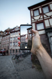 Man photographing with mobile phone