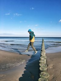 Full length of man on beach against sky