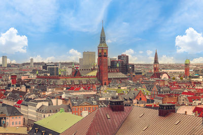 Roofs of buildings  of the old city and tower of copenhagen city hall. copenhagen, denmark