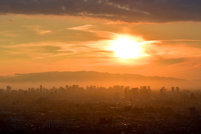 Scenic view of buildings against sky during sunset