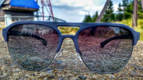 Close-up of sunglasses against sky