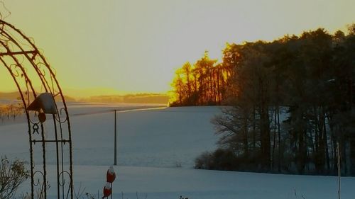 Scenic view of lake against clear sky during winter