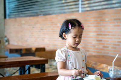 Cute girl looking at table