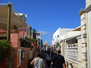 Rear view of people walking on buildings in city