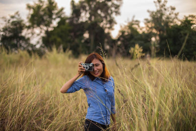 Young woman standing on field