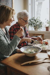 Senior couple preparing food at home