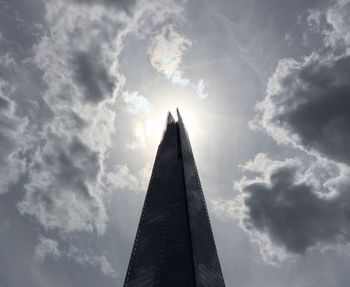 Low angle view of tower against cloudy sky