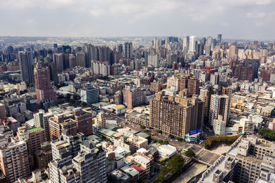 High angle view of modern buildings in city against sky