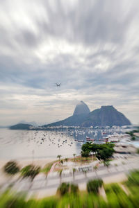 Scenic view of sea and mountains against sky