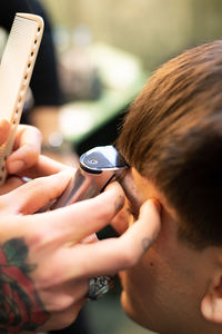 High angle view of man sitting in hair salon