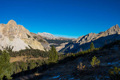 Scenic view of mountains against clear blue sky