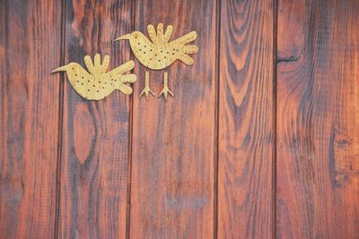 Close-up of bird carvings on wood