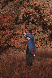 Man shielding eyes while standing outdoors