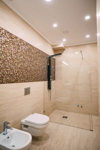 Illuminated electric lamp on wall at home