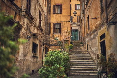 Low angle view of steps amidst buildings in town