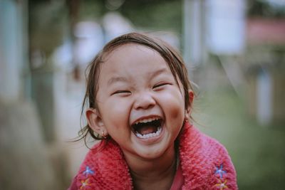 Cheerful girl with eyes closed at public park