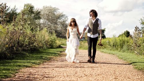 Young couple walking on footpath