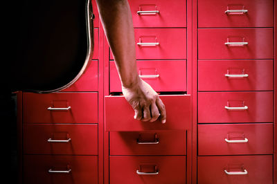 Cropped hand opening drawer