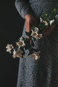 Midsection of person holding flower bouquet