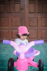 Baby girl on tricycle