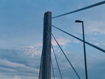 Low angle view of suspension bridge against sky