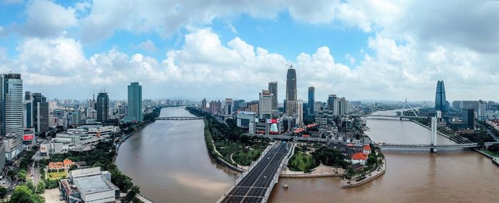 Panoramic view of river amidst buildings against sky