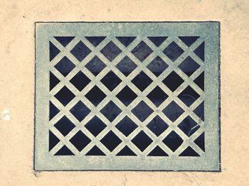 High angle view of metal grate on wall