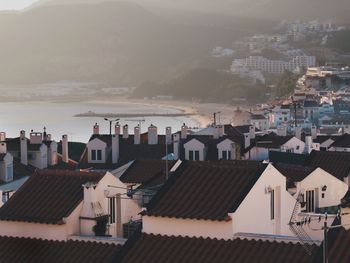 High angle view of houses in town by sea
